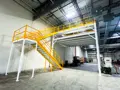 Two-tiered 24′ × 24′ steel mezzanine designed and delivered by Panel Built to solve space constraints and meet operational needs for a packaging company in North Carolina