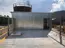 View of rooftop floor of a training tower, featuring guardrails for safety and enclosed stairs for access